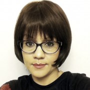 Woman with a short, dark bob and dark-rimmed glasses